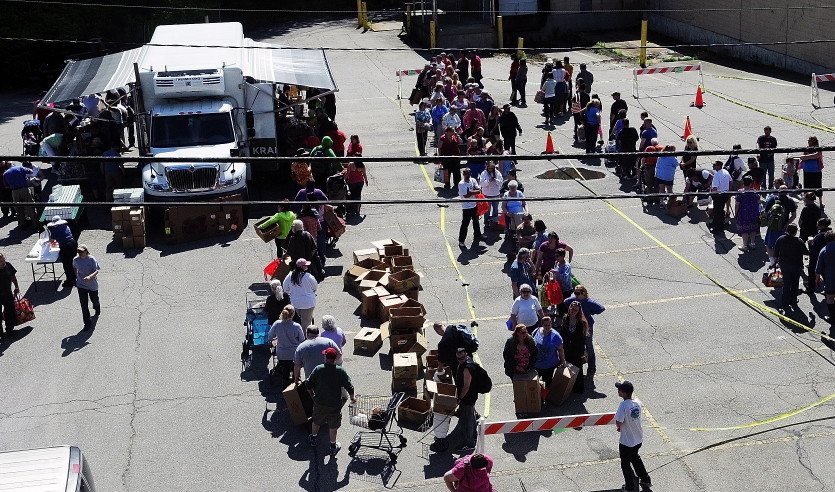 The line snakes through the parking lot in Augusta where a Good Shepherd Food Mobile event took place in 2014. Good Shepherd distributed a record amount of food last year – and estimated that it could have given away much more and still not met demand.