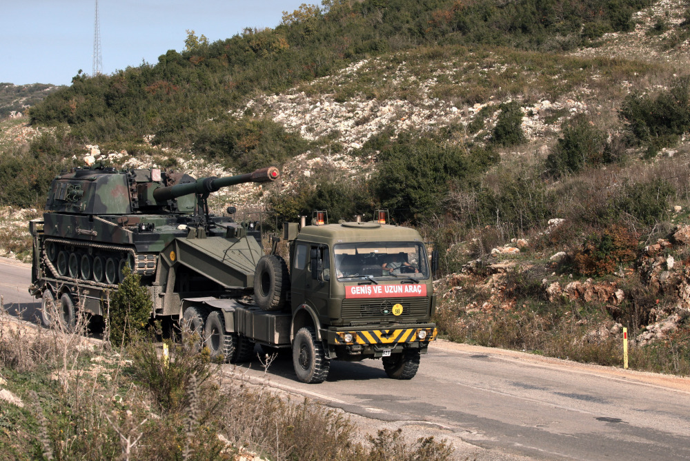 A Turkish army truck loaded with a self-propelled gun heads to the Syrian border near Yayladagi, Turkey, on Wednesday. Prime Minister Ahmet Davutoglu is seeking to reduce tensions with Moscow, saying that Russia is Turkey’s “friend and neighbor” and insisting relations cannot be “sacrificed to accidents of communication.” The Associated Press