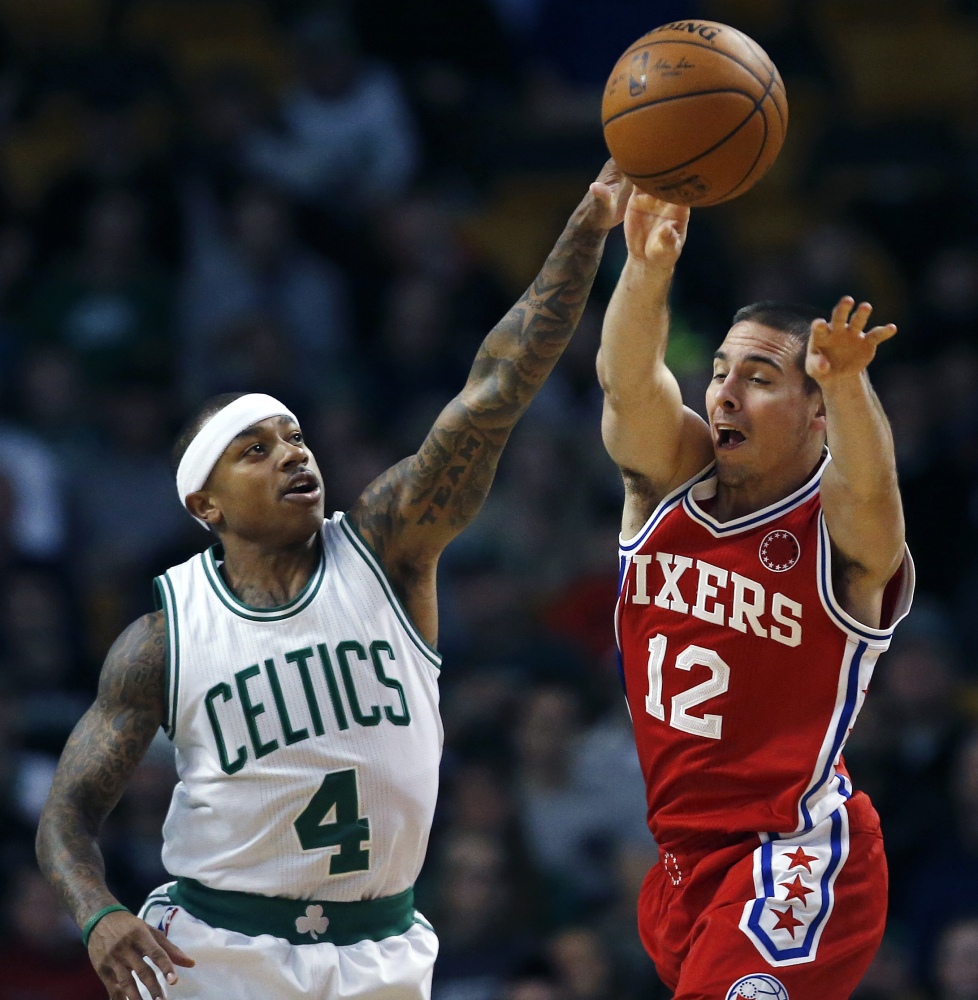 Philadelphia’s T.J. McConnell passes as Isaiah Thomas defends in the first quarter. Thomas led a late rally that pushed the Celtics to an 84-80 win over the winless 76ers.