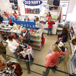 Customers wait in line Friday at Old Navy in Kittery. Mild temperatures gave Maine retailers a boost as they kicked off the holiday shopping season with 12 a.m. openings on Black Friday. According to the National Retail Federation, nearly 136 million Americans were expected to shop either online or in person over Thanksgiving weekend, an increase of about 2 million from 2014. Derek Davis/Staff Photographer