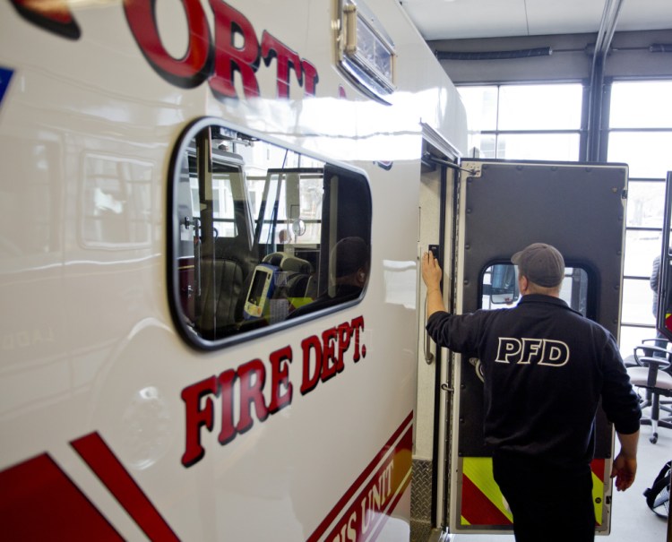 Keith Corey, a firefighter and advanced EMT with the Portland Fire Department, shuts off a light on the ambulance at Munjoy Station on Friday after doing inventory checks. The ambulance was taken out of service Wednesday and Thursday because of overtime concerns, and will operate on a “day-to-day” basis, according to the acting fire chief.