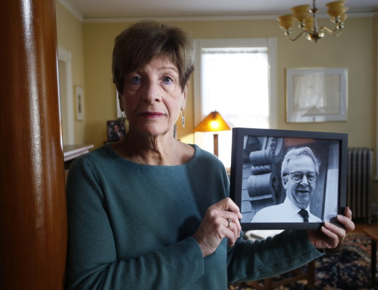 Claire Brannigan holds a photograph of her late husband, Joe Brannigan, a longtime Maine legislator who benefited from hospice care before he died in January.