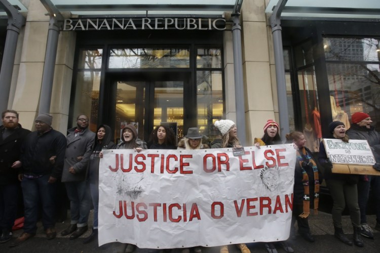 Protesters block an entrance to a Banana Republic store Friday in Chicago as hundreds hold a demonstration in response to the release of video showing an officer fatally shooting Laquan McDonald.
The Associated Press