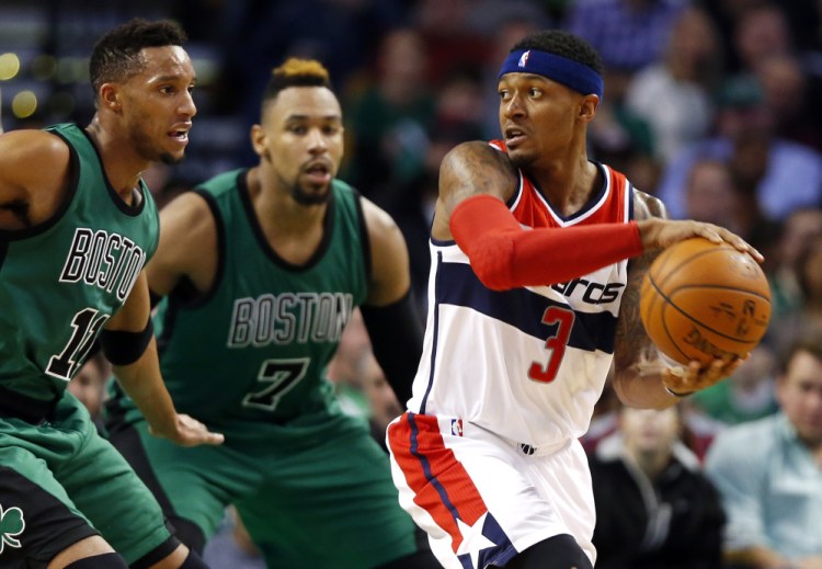 The Wizards’ Bradley Beal looks for an opening around the Celtics’ Jared Sullinger (7) and Evan Turner in the second quarter. Sullinger piled 18 points and 15 rebounds in just three quarters.