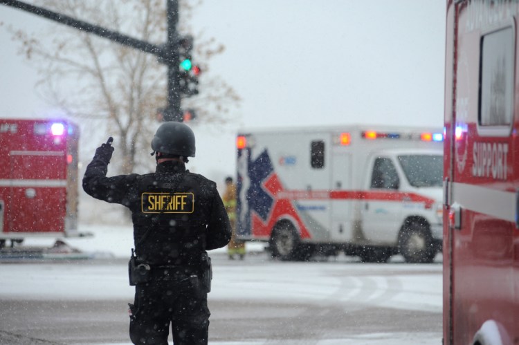 The Associated Press Police stand guard near a Planned Parenthood clinic Friday in Colorado Springs, Colorado.