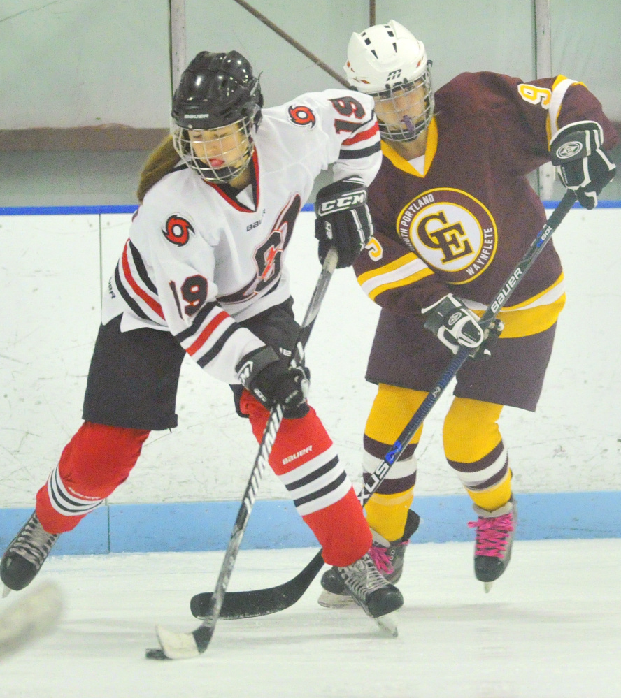 Lauren Topchik of Scarborough attempts to elude Sophie Miller of Cape Elizabeth while controlling the puck. Scarborough scored once in the second period and another into an empty net in the last minute of the game.