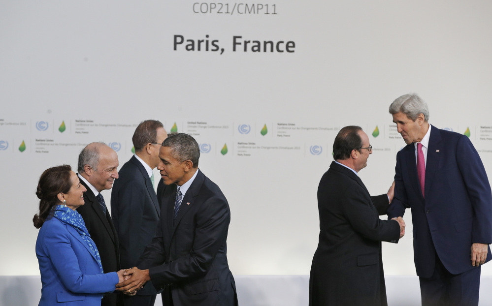 President Obama is greeted by Segolene Royal, French minister for ecology, sustainable development and energy and U.S. Secretary of State John Kerry, right, is greeted by French President Francois Hollande, as they arrive for the COP21, United Nations Climate Change Conference, in Le Bourget, outside Paris, on Monday.