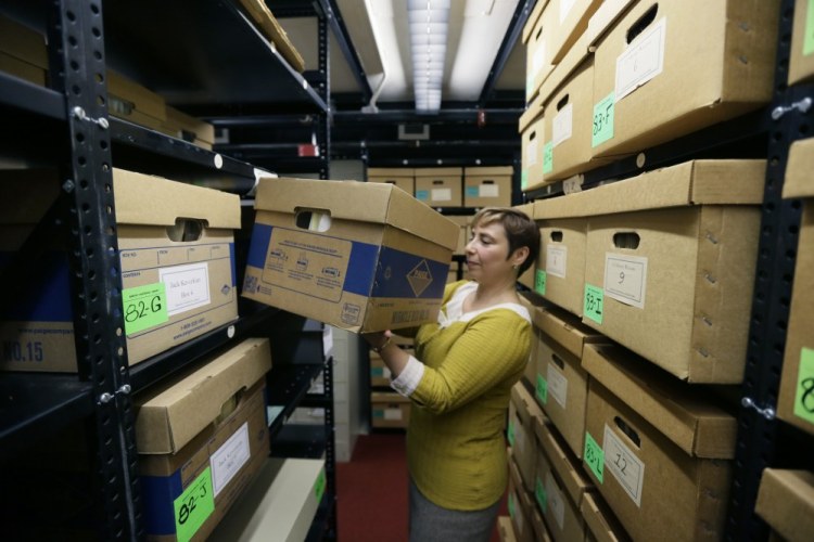 In an Oct. 22 photo in Ann Arbor, Mich., Olga Virakhovskaya, the lead archivist for collections management at Bentley Historial Museum, University of Michigan, moves a box containing files on assisted suicide that belonged to Dr. Jack Kevorkian.