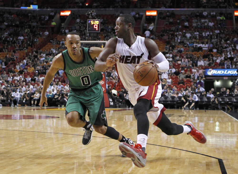 Miami Heat guard Dwyane Wade drives past Celtics guard Avery Bradley in the first quarter of the Celtics’ win Monday night in Miami.