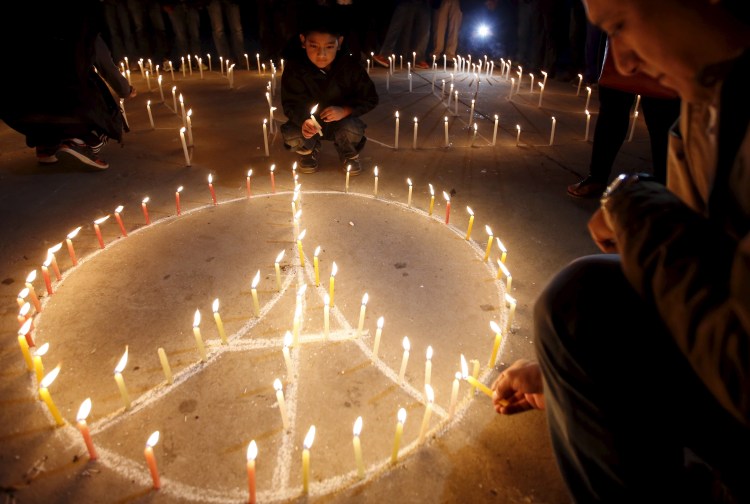 Navesh Chitrakar/Reuters
@CAP.cutline:People light candles at a vigil Sunday in Kathmandu to remember the victims of the attacks in Paris, where residents remained on edge during a second day of mourning.  Navesh Chitrakar/Reuters