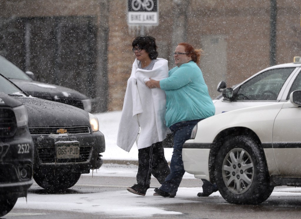 A person is escorted after reports of a shooting near the Planned Parenthood clinic in Colorado Springs, Colo. 
Andy Cross/The Denver Post via AP