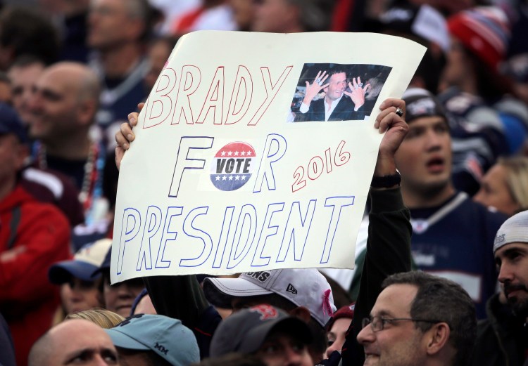 A New England Patriots fan holds a sign that supports Patriots quarterback Tom Brady for president during an NFL football game against the New York Jets in Foxborough, Mass.