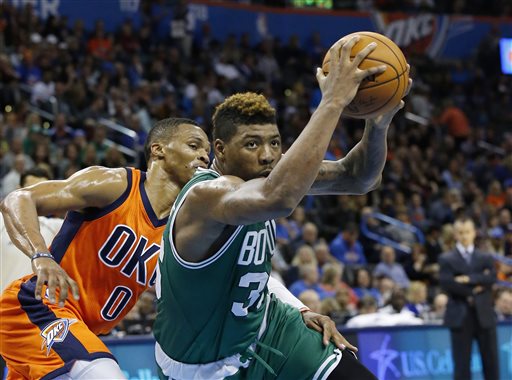 Celtics guard Marcus Smart drives past  Thunder guard Russell Westbrook in the third quarter Sunday. The Associated Press