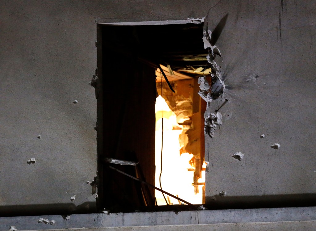 Bullet holes surround a window on the building that was raided early Wednesday in Saint-Denis, near Paris. A woman wearing an explosive suicide vest blew herself up as heavily armed police stormed the apartment where the suspected mastermind of last week's attacks was believed to be, police said.
The Associated Press