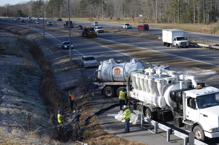 Emergency crews work to clean up diesel fuel off I-295 northbound  at Exit 15 in Yarmouth. Shawn Quellette/Staff Photographer 