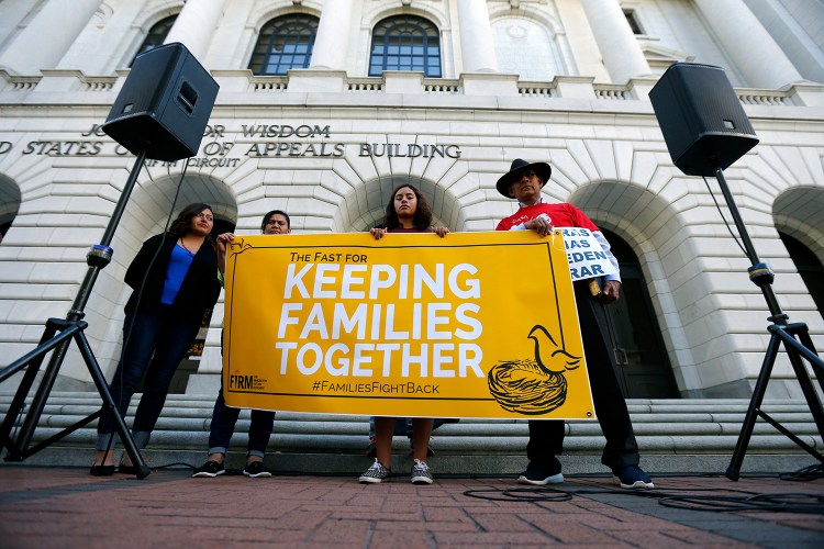 Immigration activists protest outside the federal appeals court in New Orleans, Wednesday. The Associated Press