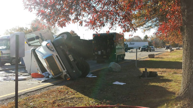 Troopers are at the scene of a tractor-trailer rollover at the northbound service plaza in Kennebunk off the Maine Turnpike. Maine State Police photo