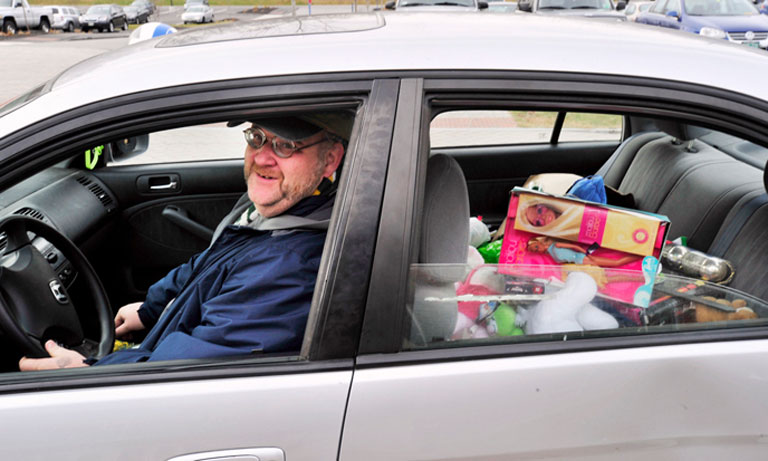 Bil Moriarty, aka Santa Bil, takes a carload of toys from a collection site at the Harold Alfond Forum on the University of New England campus in Biddeford Pool earlier this month. Shawn Patrick Ouellette / Staff Photographer