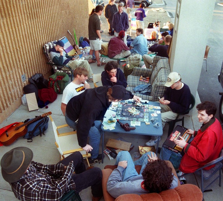 Eli Meyers, 16, of Yarmouth, picks a card in a game of Star Wars Monopoly that he and a group of Greater Portland Star Wars fans are playing while waiting in line for tickets to "Star Wars: A Phantom Menace" at the Falmouth Hoyts Cinemas on May 11, 1999.