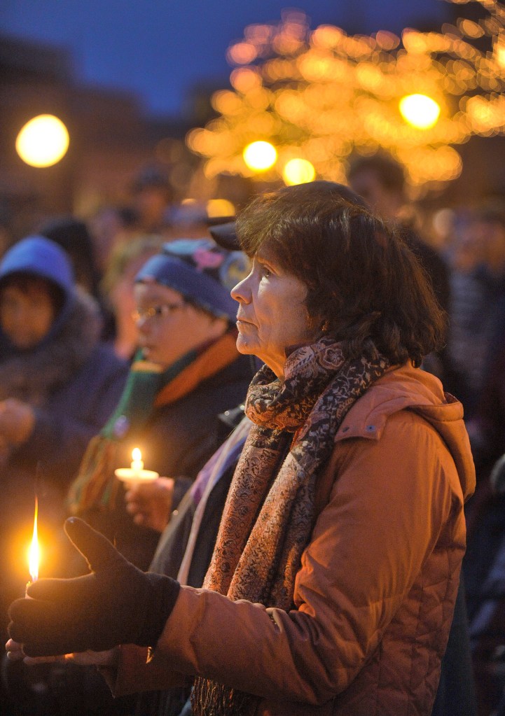 Barbara Taylor of Peaks Island participates in Monday's vigil, which marked a record number of deaths in Portland's homeless community.