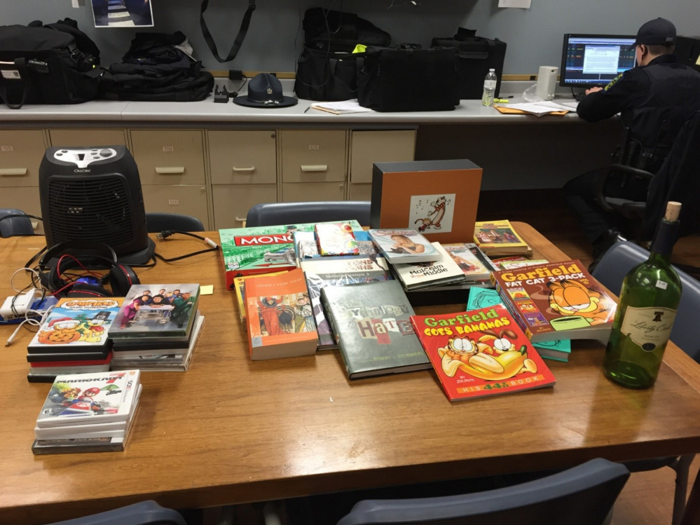 Three people, including an 11-year-old boy, were charged on Monday with burglary in Skowhegan. Police recovered items including cartoon books, DVDs and video games.