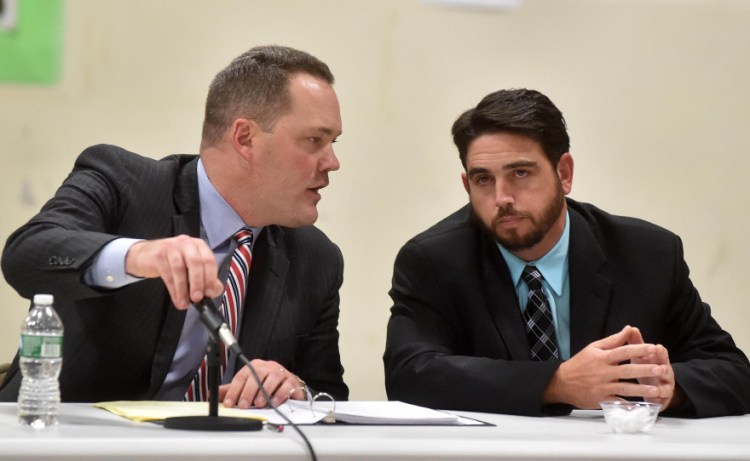 Gregg Frame, left, confers with his client, Don Reiter, during the Waterville school board hearing on his dismissal last month. The board fired Reiter Nov. 16 and his lawyer said Tuesday he won’t appeal the dismissal.