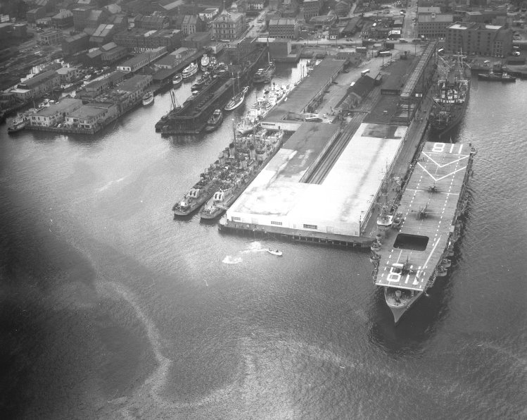 A June 1949 aerial photograph of the Portland waterfront shows the USS Sicily, an aircraft carrier, berthed at the Maine State Pier.