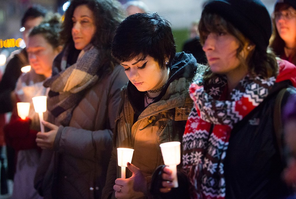 Shannon O’Connor of Portland bows her head during Tuesday's vigil, joined by Awapuhi Dancil of Cape Elizabeth, left, and Alex King of Portland.
Carl D. Walsh/Staff Photographer