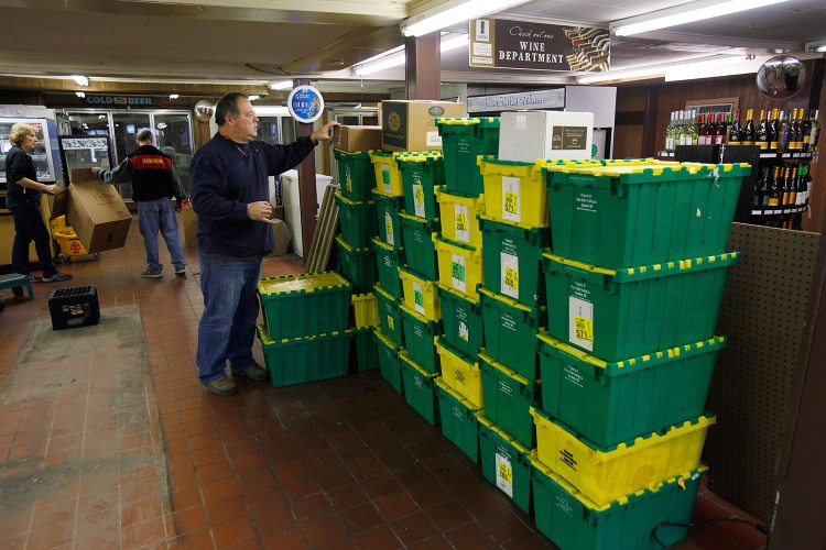David Discatio, a co-owner of Joe's Super Variety, packs up merchandise Wednesday, after the store's temporary closing.
Joel Page/Staff Photographer