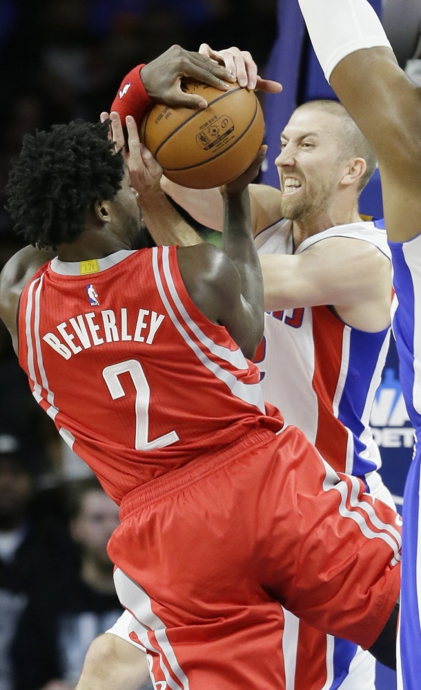 Pistons guard Steve Blake, right, and Rockets guard Patrick Beverley battle for the ball Monday in Auburn Hills, Michigan.