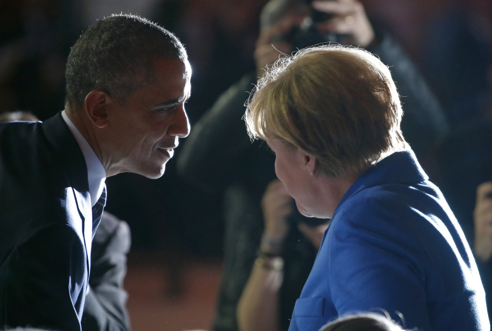 President Obama talks with German Chancellor Angela Merkel at the climate conference Monday. French Foreign Minister Laurent Fabius opened the 150-nation summit, saying “the menace of climate change is too great for us to be content with a minimalistic agreement.”
Stephane Mahe/Reuters