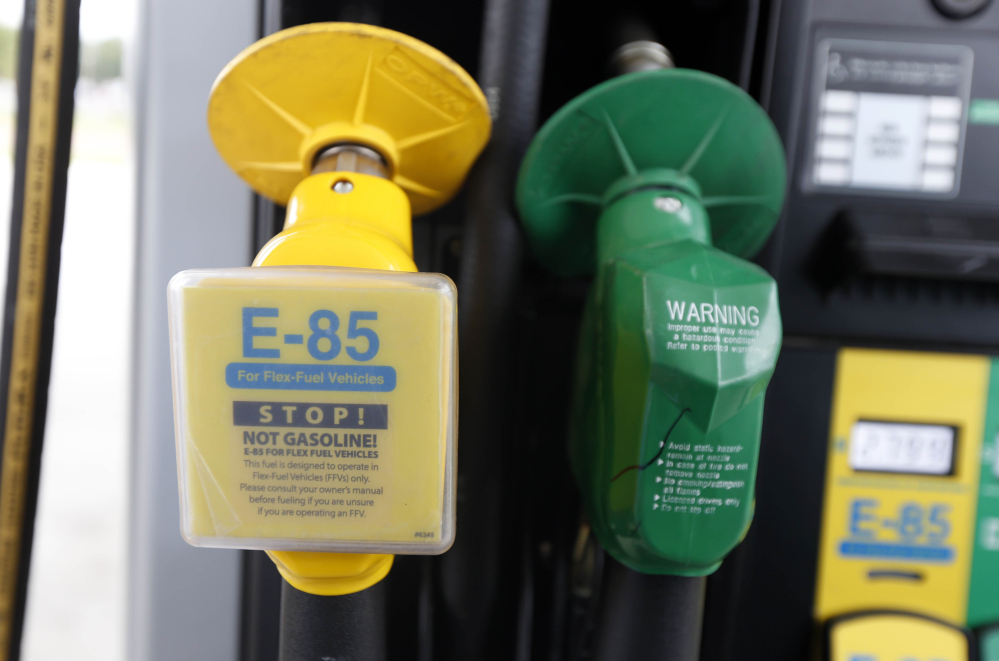 A fuel nozzle for E-85, an ethanol-gasoline blend, is on the left of a nozzle for traditional gasoline at a gas station in Batesville, Miss.