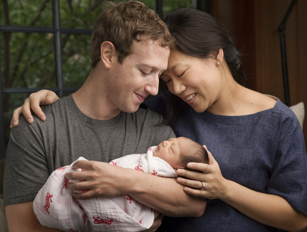 Max Chan Zuckerberg is held by her parents, Mark Zuckerberg and Priscilla Chan Zuckerberg. 
Mark Zuckerberg via AP