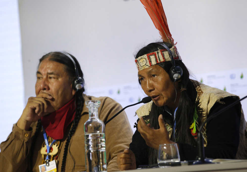Protecting forests can mitigate the effects of worldwide climate change, indigenous leaders Tom B.K. Goldtooth of Bemjdji, Minnesota, left, and Gloria Hilda Ushiqua-Santi of the Ecuadorian Amazon rainforest stress at the United Nations Climate Change Conference in LeBourget, France, Tuesday. The conference continues until next week.