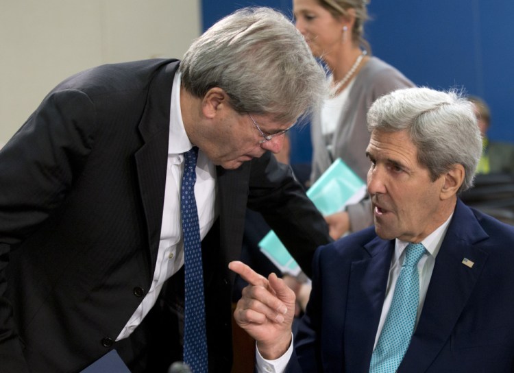 U.S. Secretary of State John Kerry, right, speaks with Italian Foreign Minister Paolo Gentiloni during a meeting of the NATO-Ukraine Commission at NATO headquarters in Brussels on Wednesday.