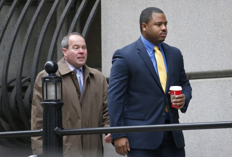 William Porter, right, one of six Baltimore city police officers charged in connection to the death of Freddie Gray, walks into a courthouse with his attorney, Joseph Murtha, for jury selection in his trial Monday in Baltimore.