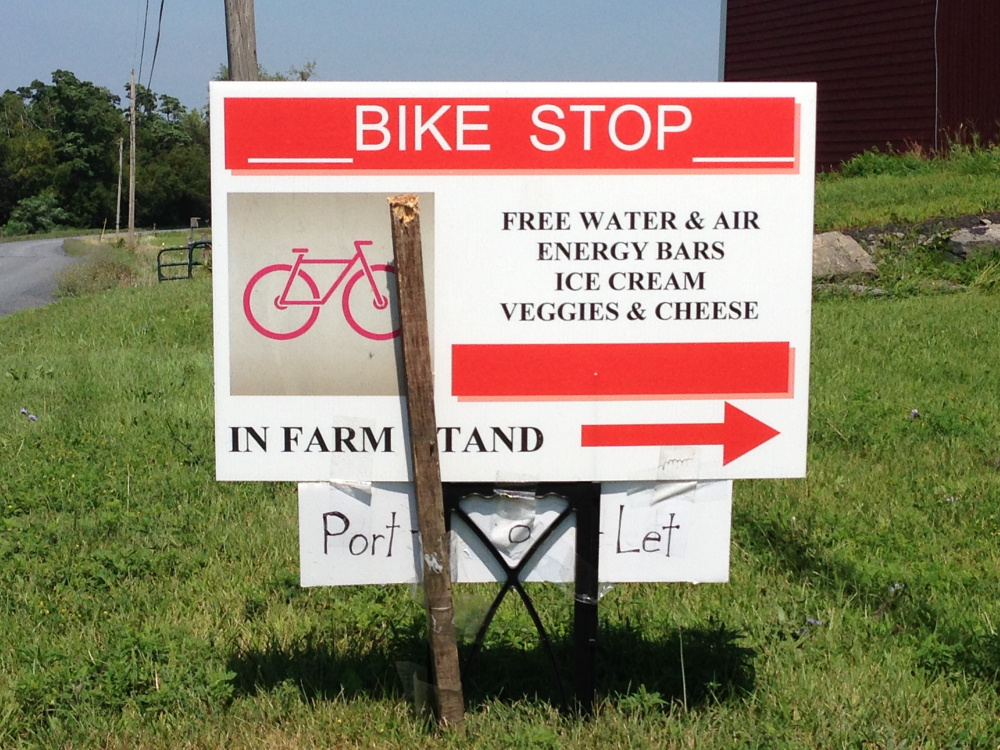 A sign by a farm stand in South Hero, Vt., invites cyclists to stop for free water and air for their tires, as well as snacks for sale. Maine’s growing trail network could use signs directing cyclists to services nearby.