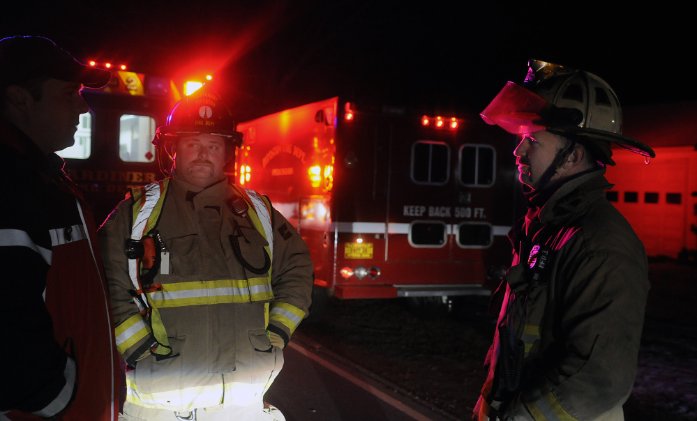 Pittston Fire Chief Jason Farris, right, and Lt. Mike Flanders speak on Nov. 23 with Gardiner Fire Department Capt. Pat Saucier at the scene of a fatal accident on Route 194 in Pittston. An 83-year-old volunteer firefighter died while crossing the road to get to his mailbox.
