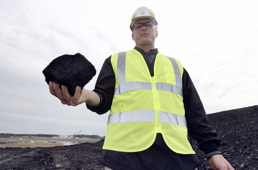 Vern Lund, president of Liberty Mine near DeKalb, Miss., holds coal that will eventually be burned in the Kemper County carbon capture power plant. The project, however, is way over budget and two years behind schedule.