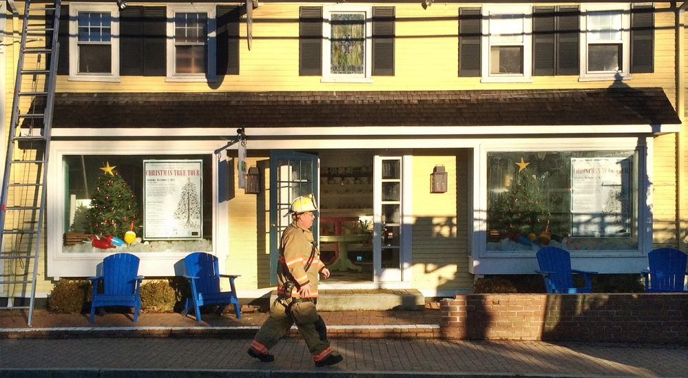 A firefighter walks past the entrance of The Sugar Shack. The Sugar Shack candy store is scheduled to be the starting point of the Prelude Christmas Tree Tour.