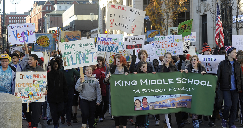 Holding posters, signs and banners, 400 students from King Middle School march to Portland City Hall to promote climate change awareness.