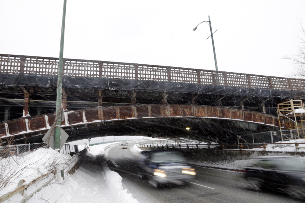 Cars travel under the Longfellow Bridge in Boston.