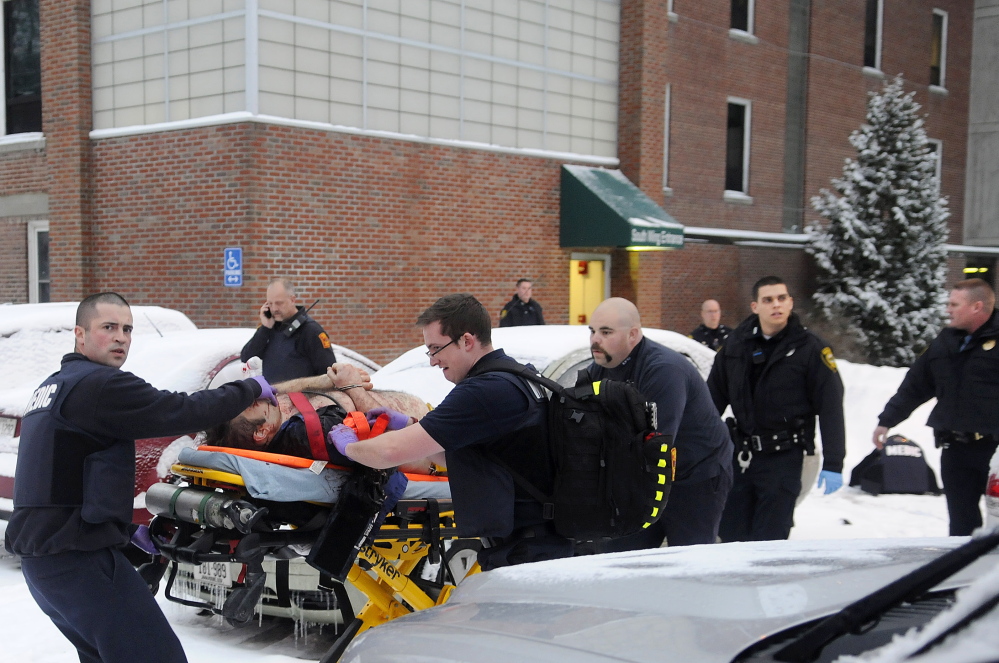 Firefighters and police transport Jason Begin, who was shot by an Augusta police officer, on Jan. 12 after a confrontation at an office in the former MaineGeneral Medical Center in Augusta.