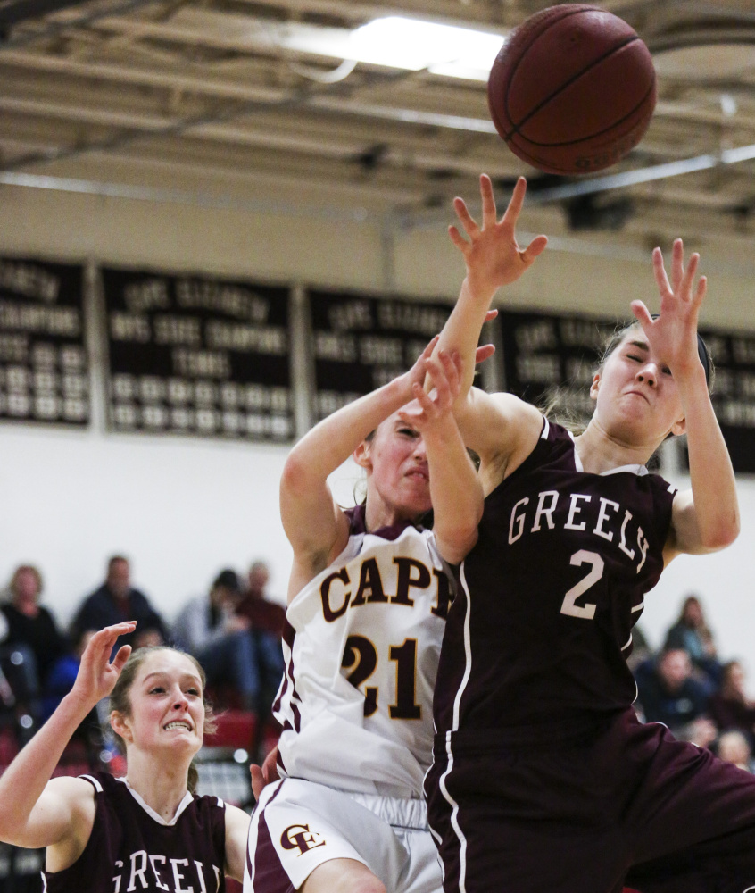 Isabel Porter of Greely, right, gets the inside position on Maddie Bowe of Cape Elizabeth to collect a rebound Friday night as Sarah Felkel of Greely moves in. Greely, the defending Class B state champion, pulled away to a 45-24 victory in its opener.