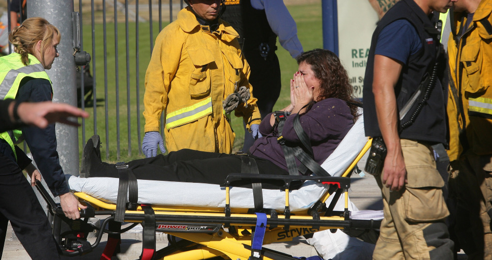 A victim is wheeled away following a mass shooting that killed 14 and injured 21 more at a social services facility Wednesday in San Bernardino, Calif. An average of 85 firearms deaths occur each day in the U.S.
