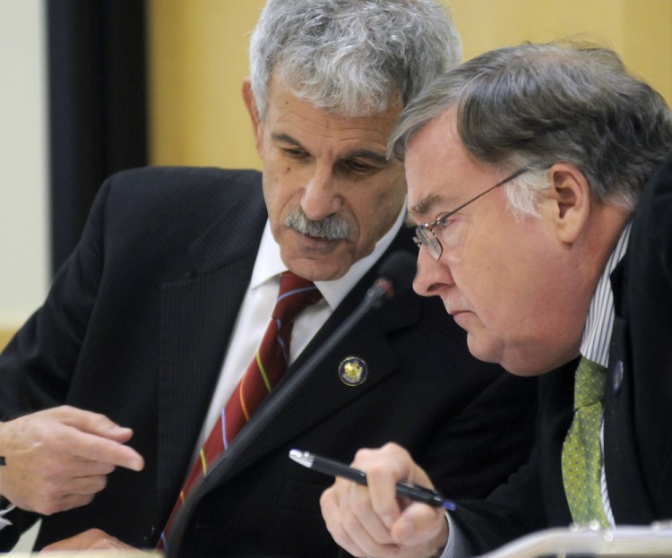 Sen. Roger Katz, R-Augusta, left, and Rep. Chuck Kruger, D-Thomaston, confer during a hearing about the governor’s role in Speaker Mark Eves’ losing a job at a charter school.