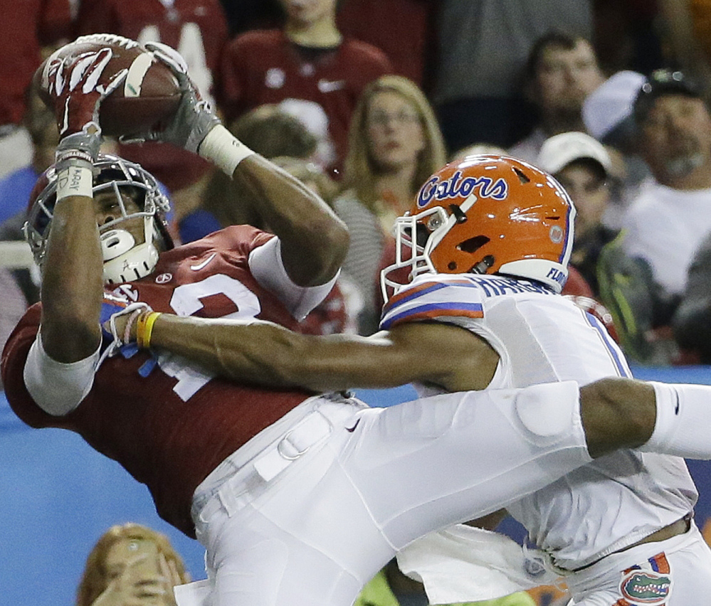 ArDarius Stewart of Alabama hauls in a touchdown pass Saturday while being defended by Vernon Hargreaves III of Florida during the second half of the Southeastern Conference championship game at Atlanta. The Crimson Tide rolled to a 29-15 victory.