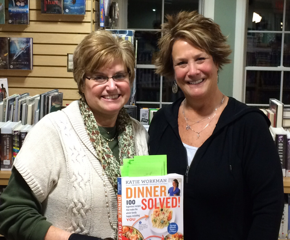 Springvale Public Library assistant director Dawn Brown, left, and Cook the Book Club member Mary Ann Ratteree with “Dinner Solved!” by Katie Workman, the first cookbook the group tested recipes from and reviewed.