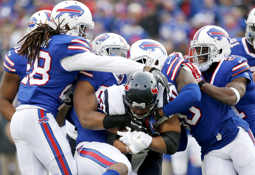 Texans running back Jonathan Grimes is gang-tackled by Buffalo defenders during the Bills’ 30-21 victory Sunday in Orchard Park, N.Y.