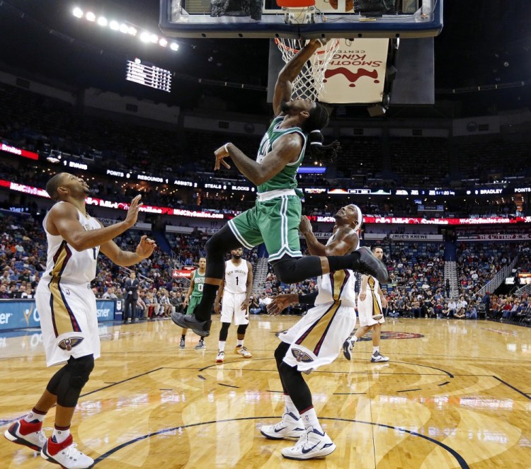 Celtics forward Jae Crowder drives to the basket in front of New Orleans Pelicans guard Eric Gordon, left, and forward Dante Cunningham in the first half of Monday night’s game in New Orleans. Crowder scored 17 points in the game.